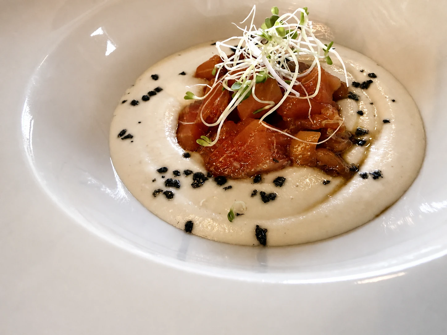 Sobremesa ajo blanco with a carefully composed seasonal garnish
