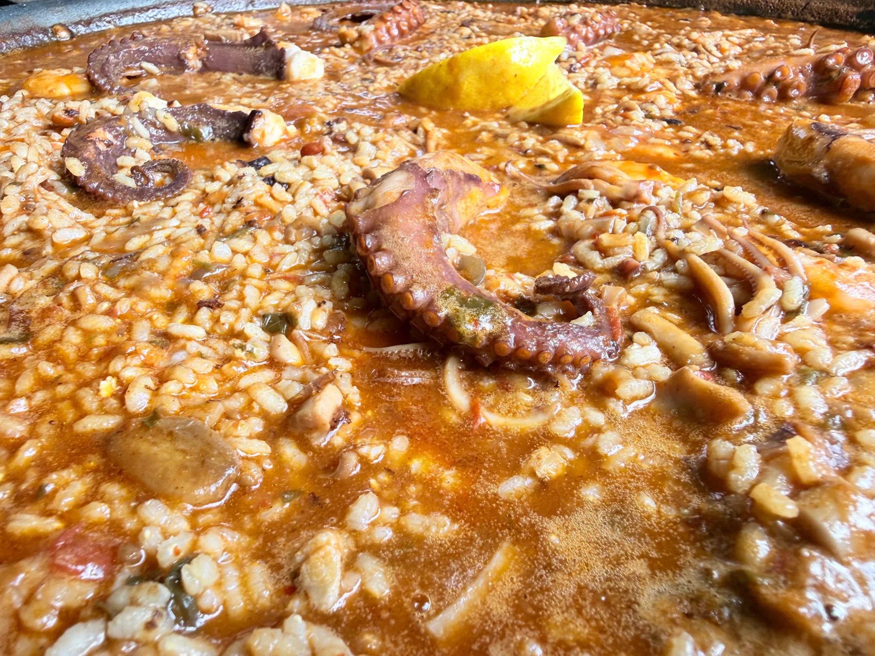 A large Sobremesa paella cooking in the kitchen